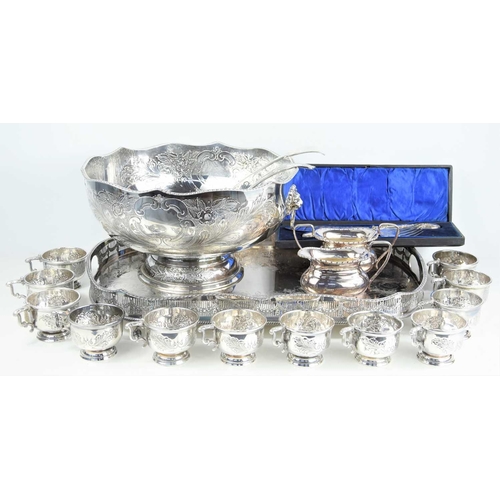 318 - A large silver plated Victorian style punch bowl with embossed foliate decoration with matching cups... 