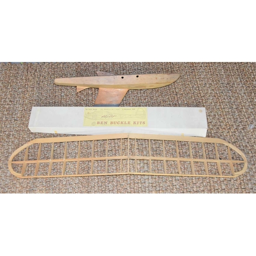 329 - A Ben Buckle model aeroplane kit together with a model yacht hull.