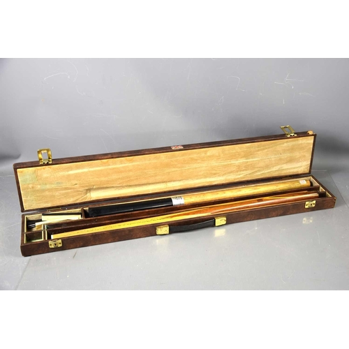 332 - A vintage Goldmaster snooker cue in a hard case.