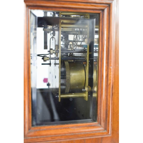 34 - A mahogany cased bracket clock, with domed top above a bevelled glass doors enclosing a silvered Rom... 