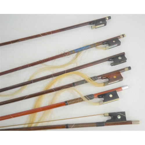 395 - A group of 19th century and later violin bows to include examples by Vuillaume and P&H, a/f.