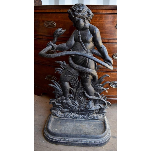 452 - A cast iron umbrella stand in the form of a cherub and snake.