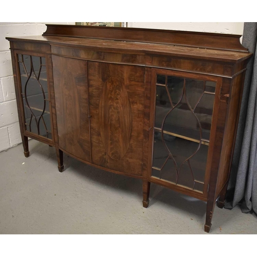 455 - A mahogany sideboard, with two astragal glazed panel doors, flanking a bow front centre, raised on s... 