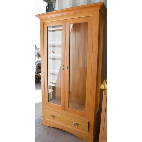 467 - A modern beech display cabinet, with two glazed doors and drawer below, 190cm high by 106.5cm wide b... 