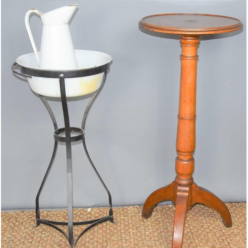 470 - A mahogany torchere together with an enamel wash bowl and jug on a wrought iron stand.