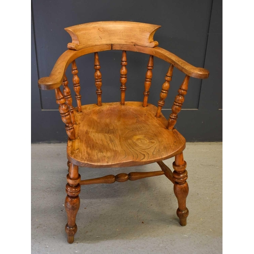 478 - A 19th century smokers bow armchair, with turned spindle back, shaped seat and turned legs and H str... 