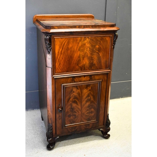 482 - A 19th century mahogany music cabinet, the top section lifting up above a panelled flame mahogany ve... 