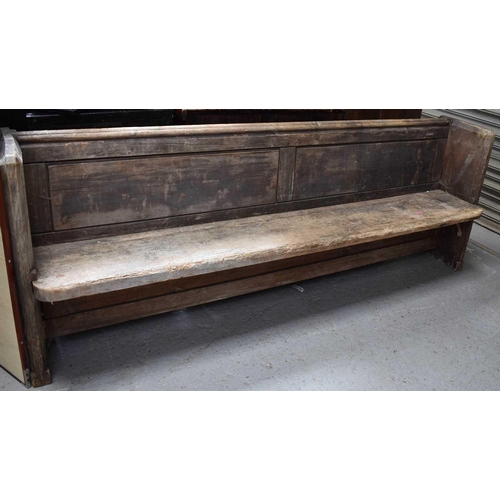 485 - A long pine church pew, 82cm high by 222cm by 41cm deep.