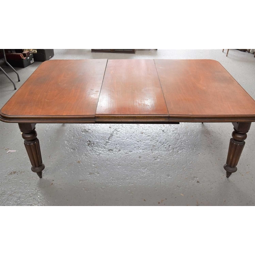 486 - A Victorian mahogany wind out dining table with extra leaf, 69cm high by 180cm by 120cm.