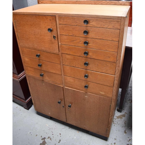 488 - A mid century beech haberdashery cabinet, comprising various drawer and cupboard doors. 106cms tall ... 