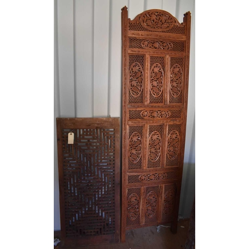 489 - A bi-fold Indonesian hardwood carved screen, together with a carved panel, the screen measures 182cm... 