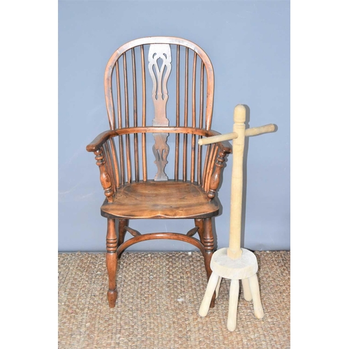 491 - A yew and elm wood Windsor chair with bent wood top-rail and arm rests, linked by a pierced splat an... 