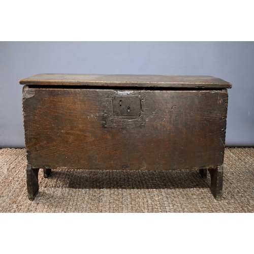 494 - A 17th century boarded oak coffer, with V cut end boards, chip carved corners, candlebox interior, a... 