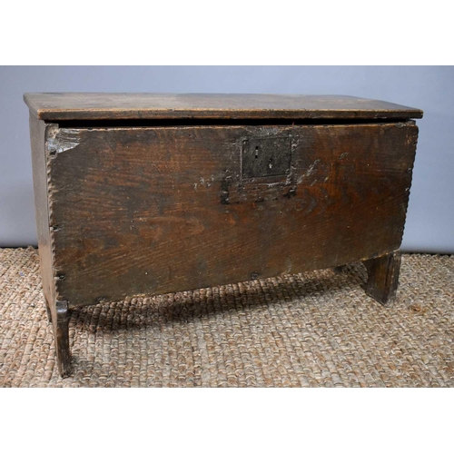 494 - A 17th century boarded oak coffer, with V cut end boards, chip carved corners, candlebox interior, a... 