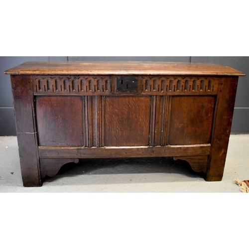 501 - An 18th century oak coffer, with nulled frieze above three panels, raised on stile and bracket feet,... 