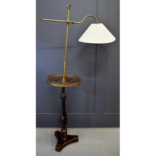 502 - An antique black lacquered and brass chinoiserie reading lamp, the height adjustable arm above a cir... 