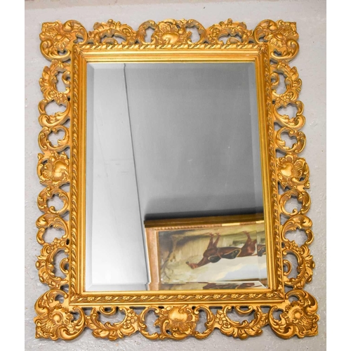 127 - A 20th century giltwood wall mirror, with scrollwork decoration, together with a modern giltwood rec... 