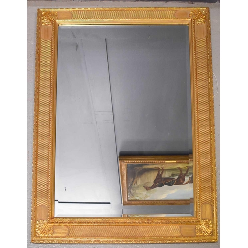 127 - A 20th century giltwood wall mirror, with scrollwork decoration, together with a modern giltwood rec... 