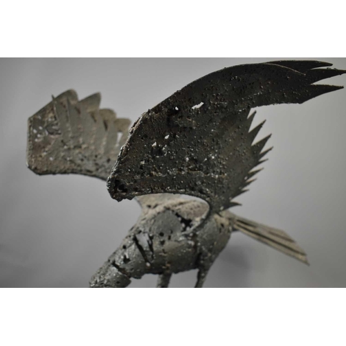 188 - A metalwork sculpture, in the form of a crow with outspread wings, 60cm high.