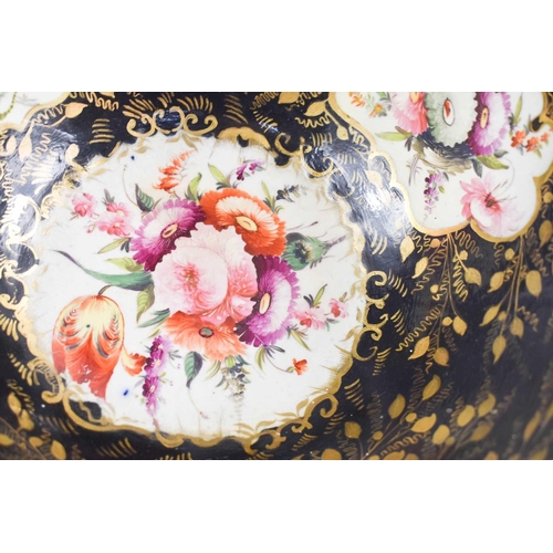 201 - A 19th century black ground bowl, painted with floral cartouches, and highlighted with gilding, 30cm... 