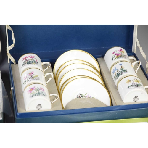 205 - A Royal Worcester set of six coffee cans and saucers decorated with flowers in a fitted box together... 