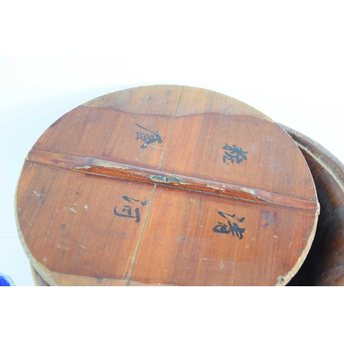 256 - A Chinese wooden coopered container and cover, the cover having handpainted calligraphy marks inside... 