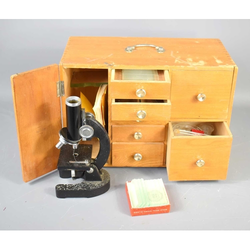 302 - A vintage SPI microscope with oak cased cabinet with various drawers containing slides, tweezers, pe... 