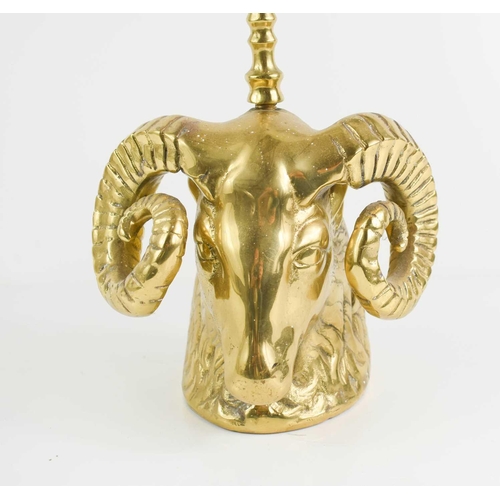 323 - An antique brass door stop, in the form of a rams head, with hoop handle, 49cm high.