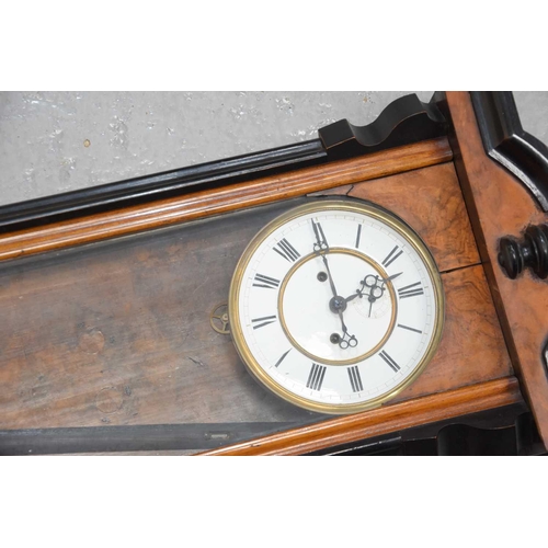 337 - A mahogany cased Vienna wall clock with enamel dial and Roman numerals.