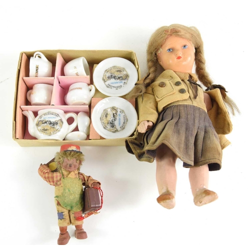 388 - A vintage doll together with a miniature tea set.