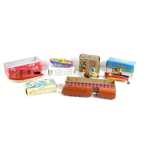 390 - A group of vintage tinplate toys to include a steam boat, locomotive, mechanical circus plane and ot... 