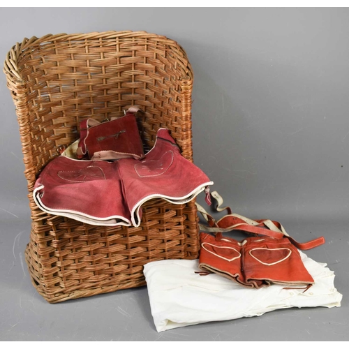 392 - Two red leather German children's lederhosen and an Edwardian christening gown, together with a chil... 