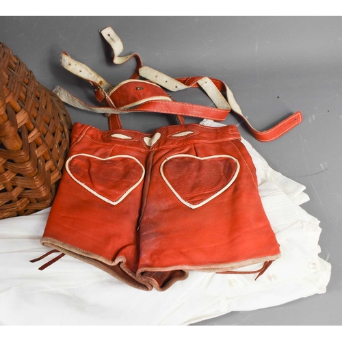 392 - Two red leather German children's lederhosen and an Edwardian christening gown, together with a chil... 