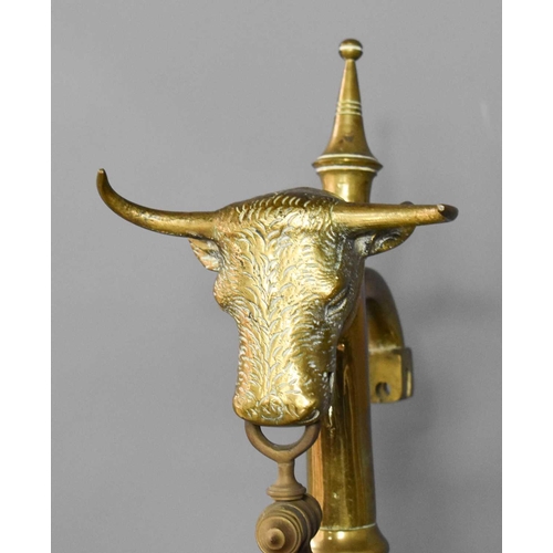 418 - A large antique brass Portuguese balance / weighing scales, with a bulls head surmount, the base ins... 