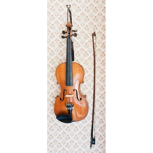 425 - An antique Violin and bow, maple with two piece back.