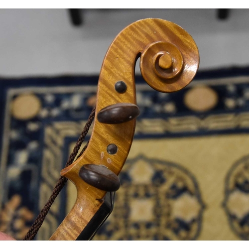 425 - An antique Violin and bow, maple with two piece back.