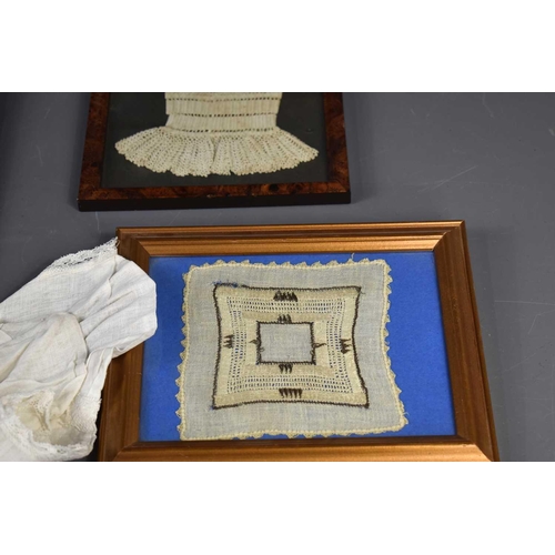 439 - A group of framed antique lace to include a child's bib, bonnet and two cuffs together with a babies... 