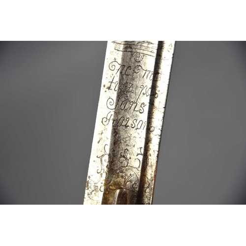 498 - A French late 18th century sword, of curved form, engraved to the blade with motto 'Ne moi tirez pas... 