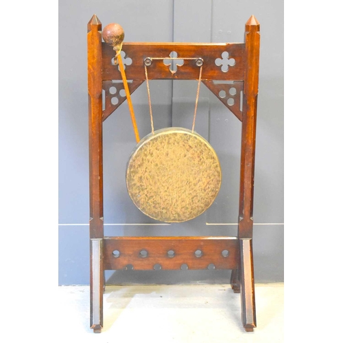 516 - A Victorian Gothic style ceremonial dinner gong with fret pierced decoration and raised on trestle l... 