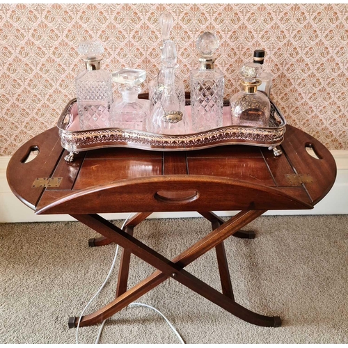 520 - A mahogany butler’s tray, with pierced handles, on folding X frame support.