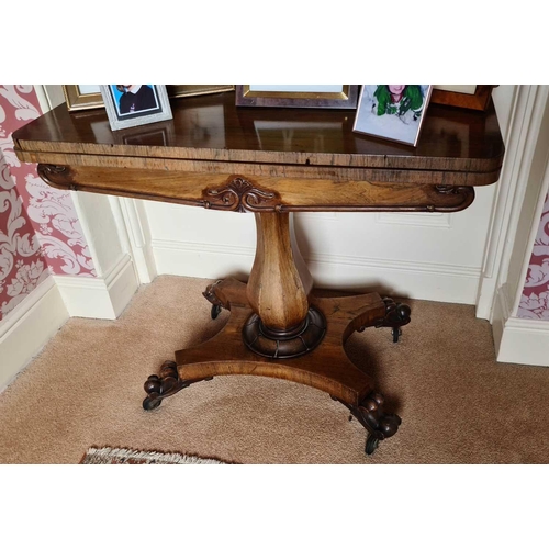 527 - A 19th century rosewood card table, with baluster column, triform base, and raised on castors, 77cm ... 