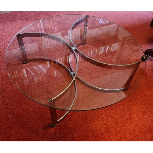 528 - A contemporary glass top coffee table with C form chrome base, 91cm diameter by 64cm high.