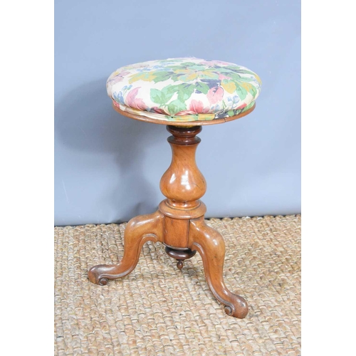 537 - A Victorian adjustable piano stool with flower upholstery.