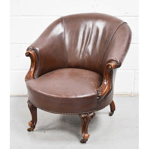 548 - A 20th century antique style leather and mahogany tub chair.