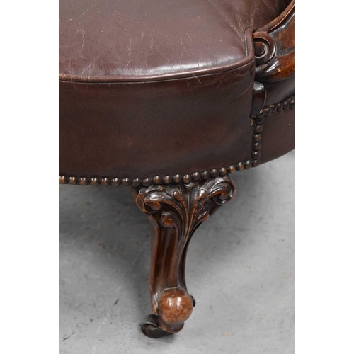 548 - A 20th century antique style leather and mahogany tub chair.