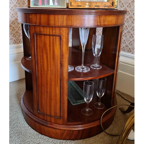 556 - A 20th century mahogany cylinder form bookcase, 64cm high by 58cm diameter.