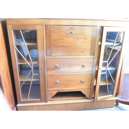 558 - A 20th century mahogany cabinet, the pull down front above two drawers with two glazed doors either ... 