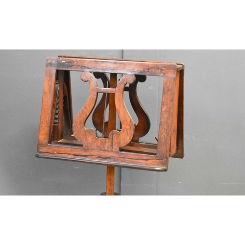 578 - A 19th century rosewood music stand with twin height adjustable book rests above a lobed column and ... 