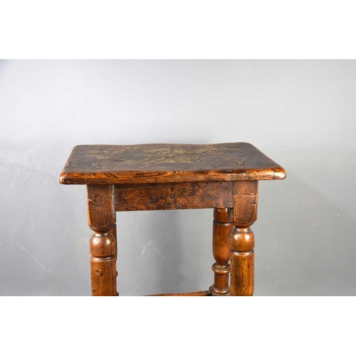 581 - An early 18th century oak joint stool.