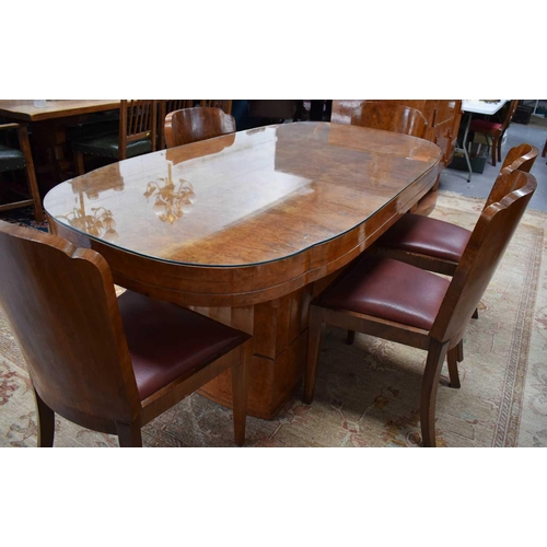 614 - Manner of Harry and Lou Epstein: An Art Deco maple dining table with rounded rectangular top, raised... 